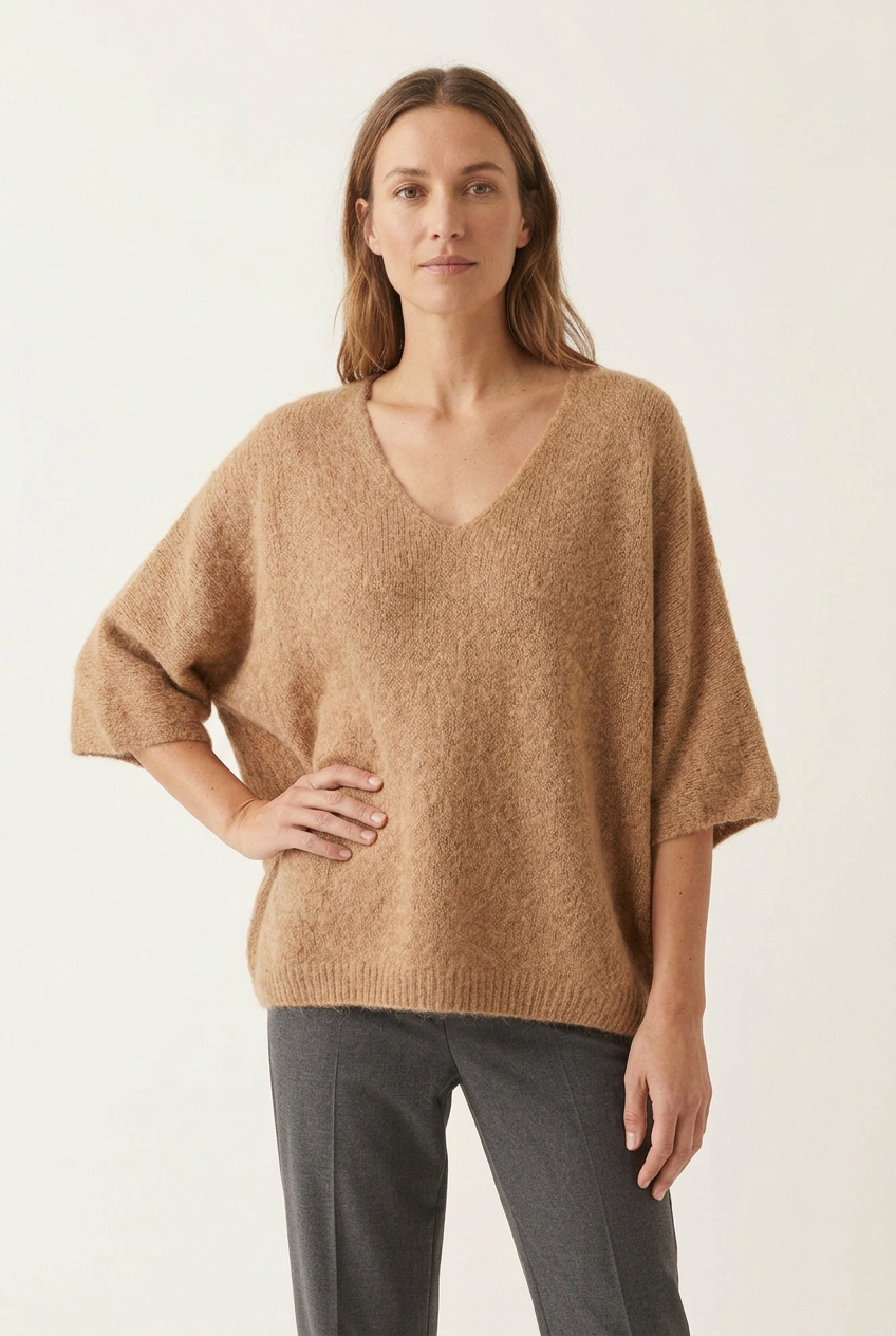 Model wearing the sweater with a relaxed arm position
